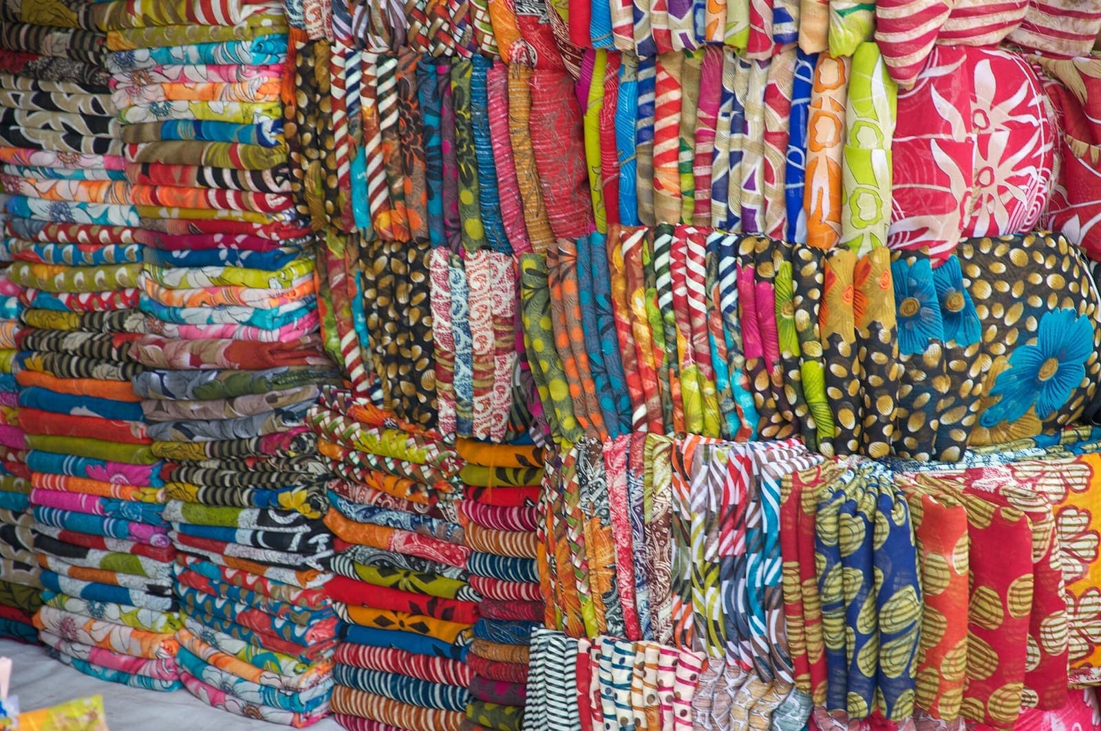 Stacks of brightly coloured cloth for sale in Kinari Bazaar, Agra