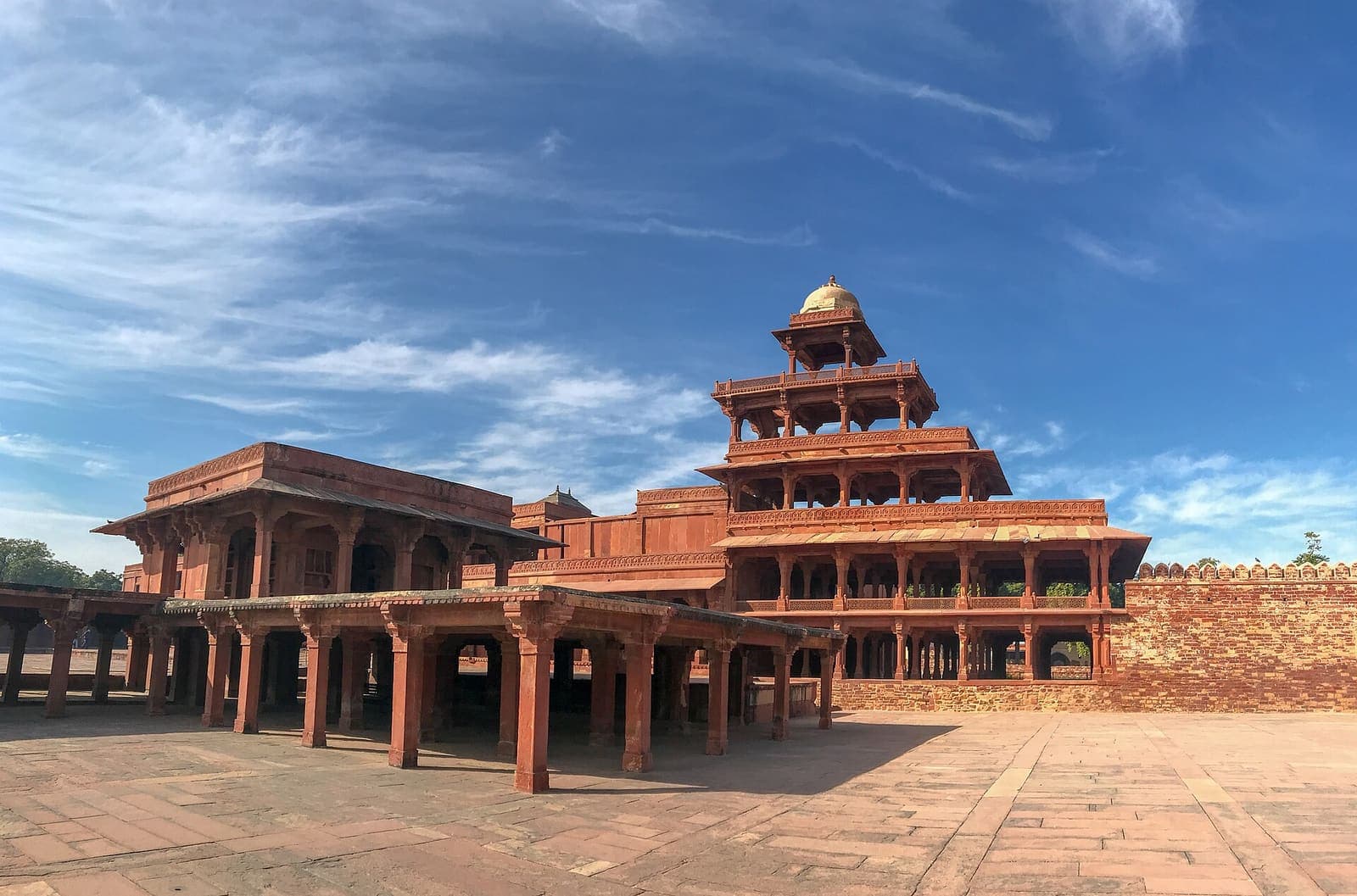 Panch Mahal at Fatehpur Sikri, a five-storey red sandstone pavilion of open pillared floors under a blue sky