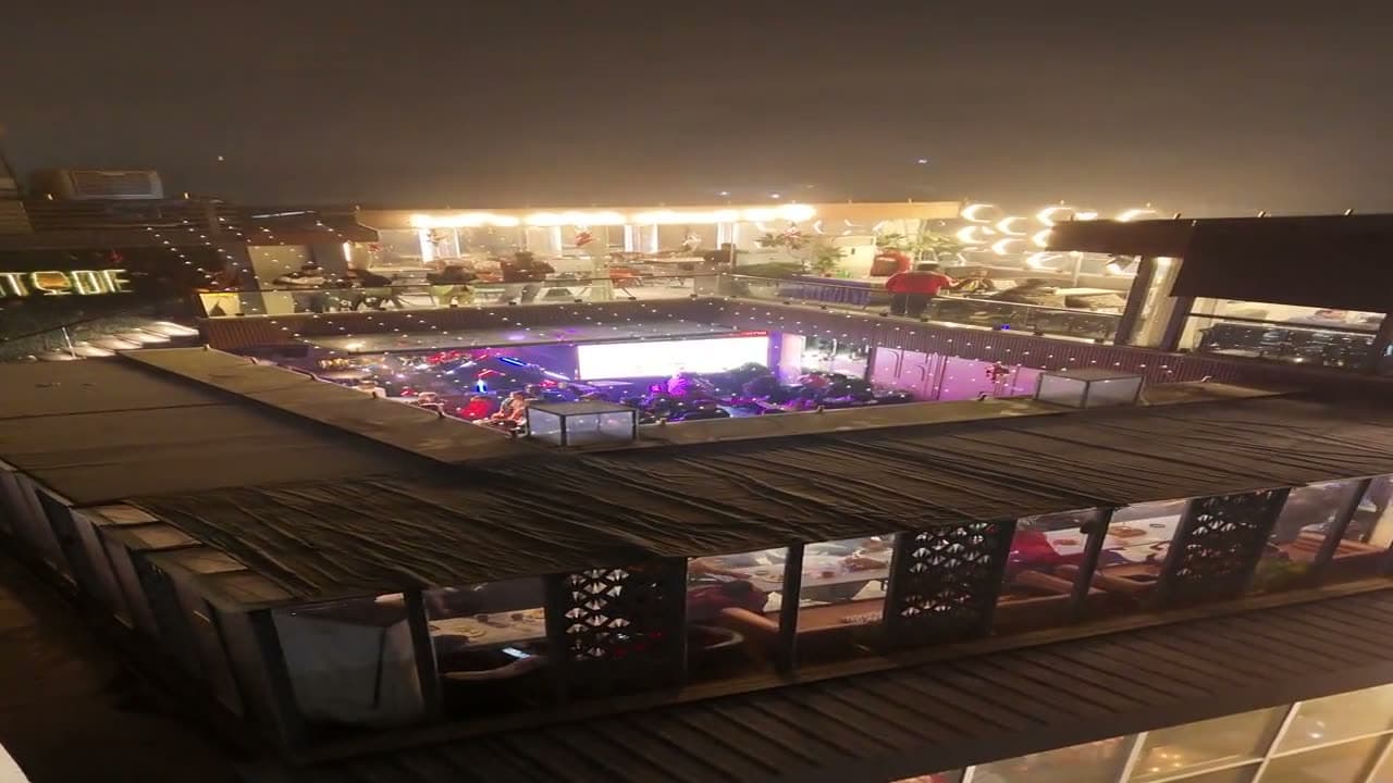 Aerial view of the Altitude rooftop terrace lit up at night above MG Road 2 in Agra