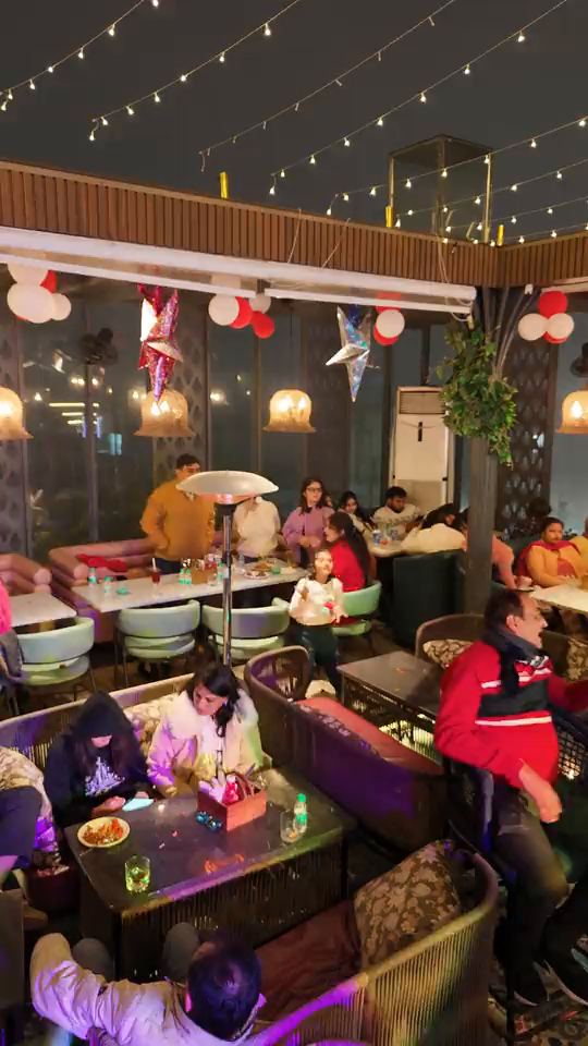 The covered terrace at Altitude on New Year’s Eve, every table taken by families and friends, heaters on, paper stars and balloons overhead